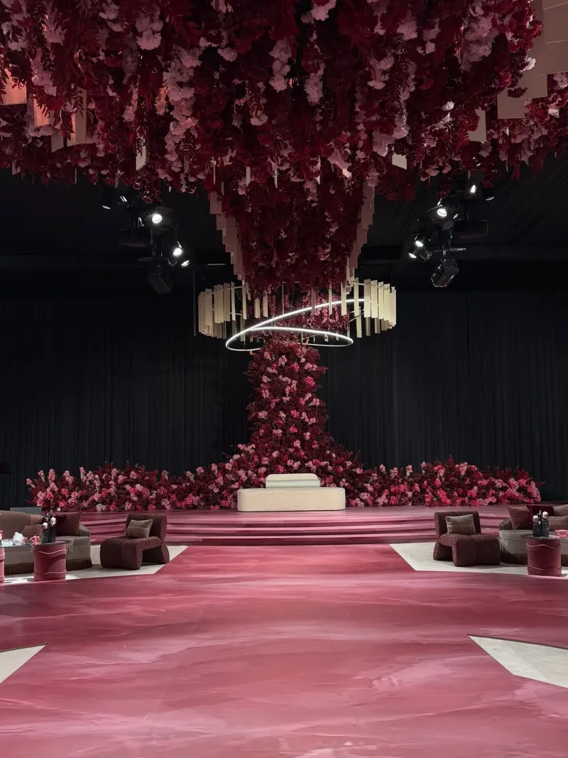 A giant tree of roses hanging from the ceiling above the couple's stage